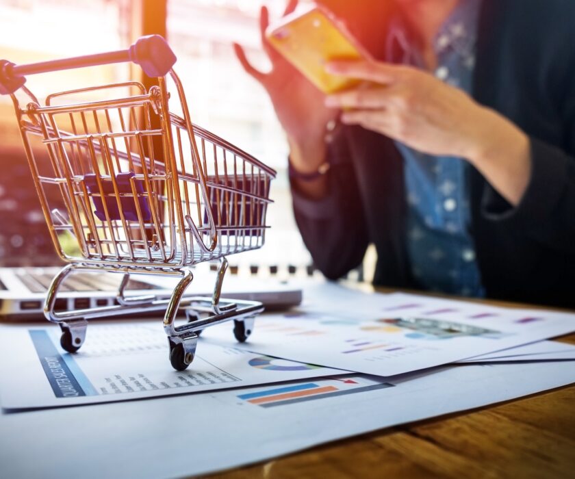 Cropped image of woman inputting card information and key on phone or laptop while shopping online